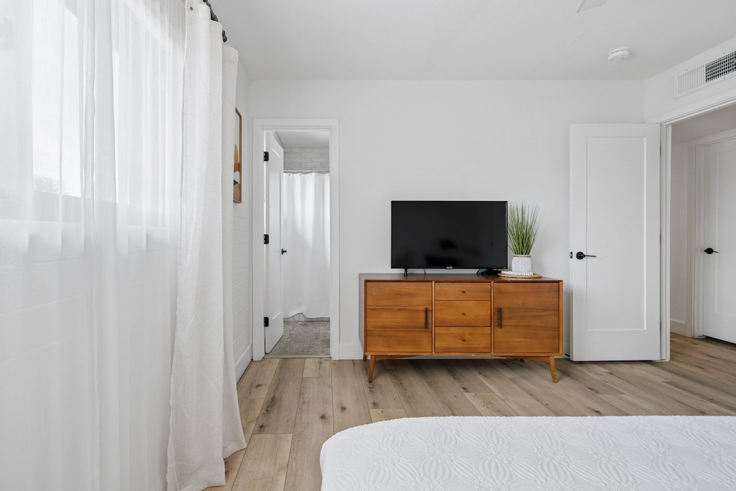 Bedroom with wooden TV stand