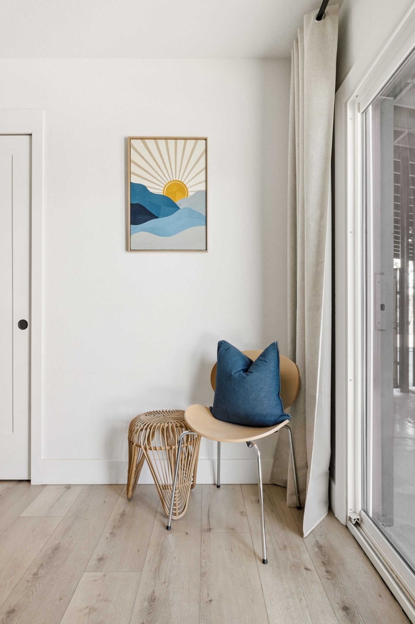 Bedroom corner with sunrise artwork
