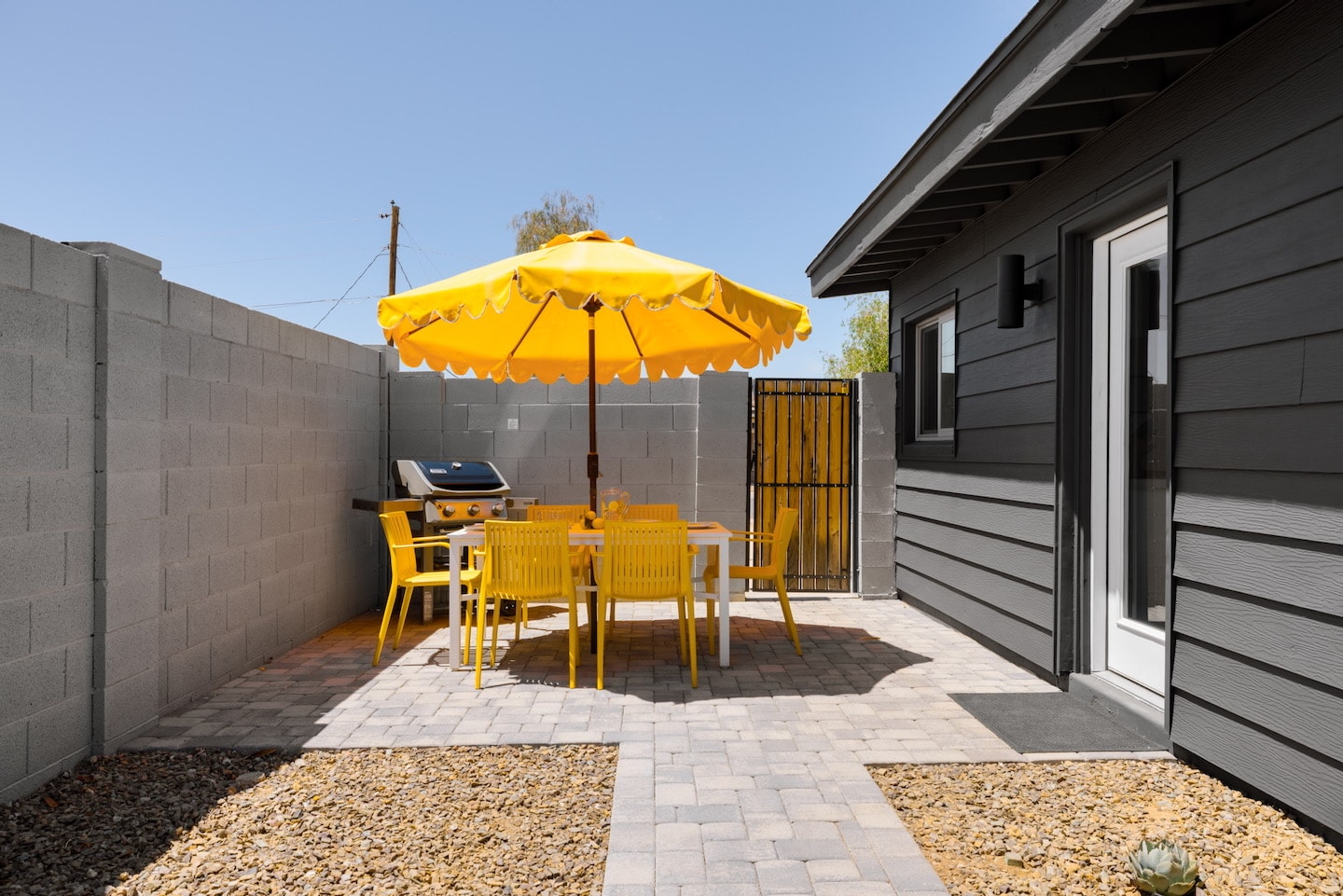 Outdoor dining set with yellow umbrella